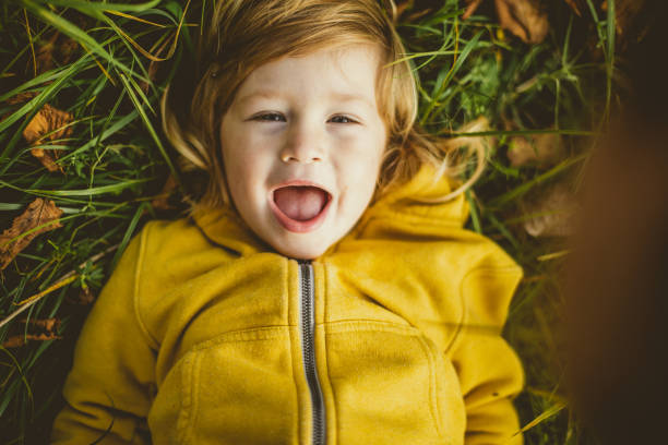 istock Toddler Lying Down in Grass, Smiling 1060054326