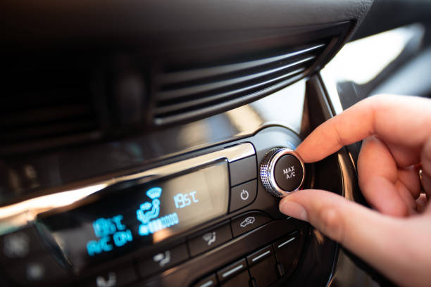 istock Man turning on car air conditioning system 1060064398
