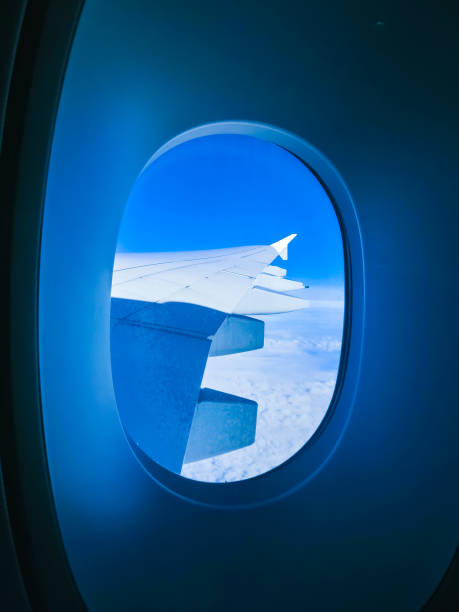 istock View from an airplane on a blue sky and white clouds. Flying on the airplane. 1060065200