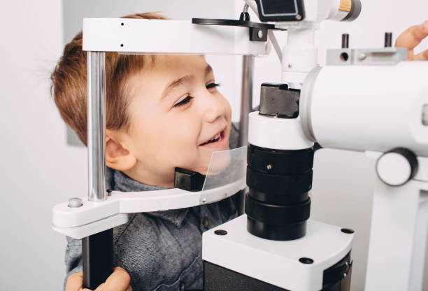 istock Happy boy receiving eye exam at clinic 1060077020