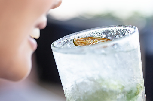 Unrecognizable woman enjoying her cold ,mojito