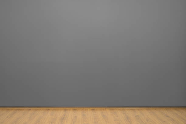 The gray wall and a brown floor