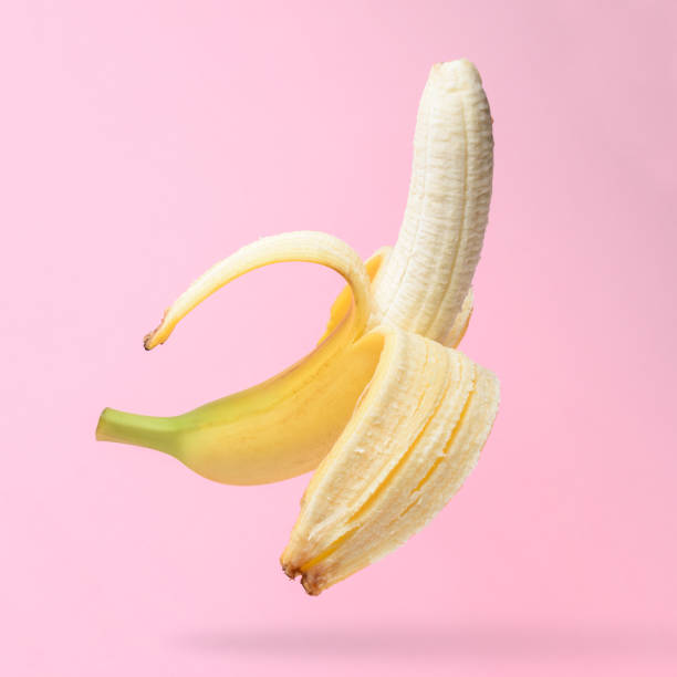 istock Peeled banana on pink background. Minimal concept. 1060092948