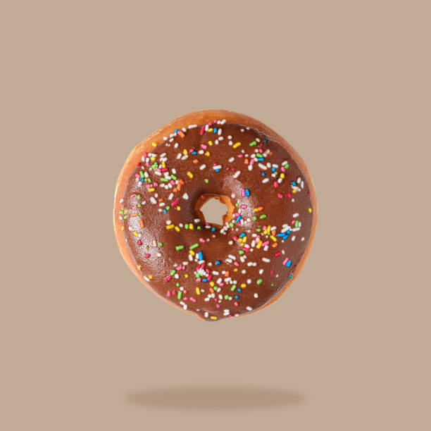 istock Glazed donut on brown pastel background. Flat lay. Creative mini 1060094020