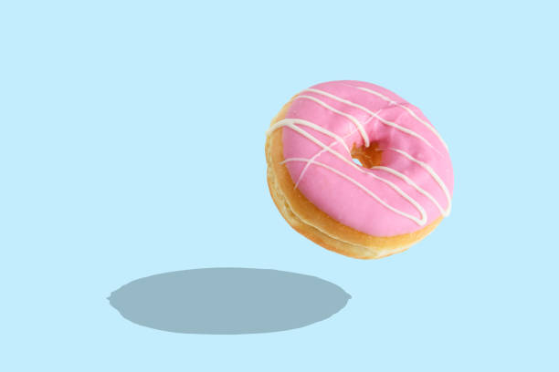 istock Glazed donut on blue pastel background. Creative minimal concept 1060094024