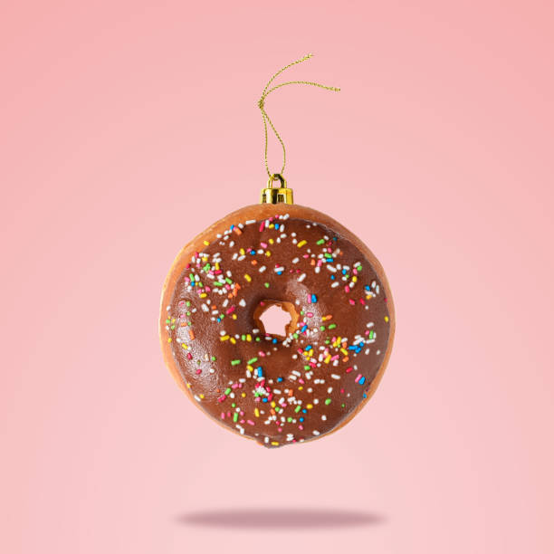istock Christmas bauble decoration made of chocolate doughnut on pink b 1060094032