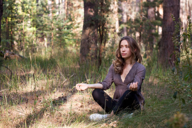 istock young woman  meditates, practicing the smiling meditation 1060094152