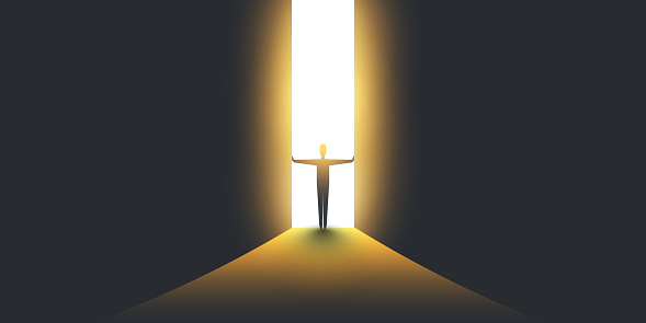 Businessman Standing in Dark, Symbol of Light at the End of the Tunnel