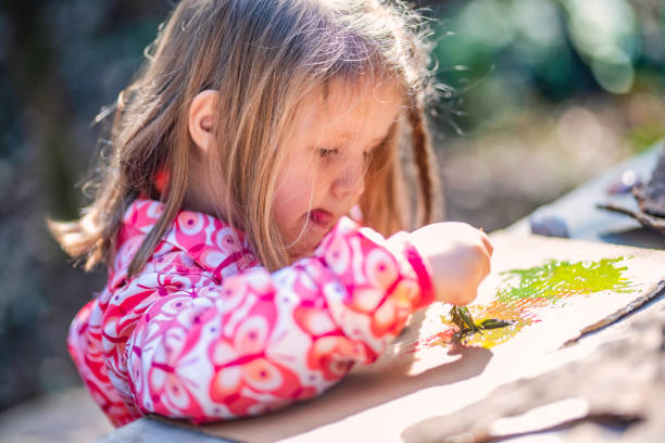 istock Little girl painting 1060115124