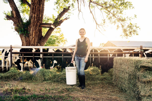 istock Young female farm worker with cattle portrait 1060117322