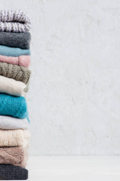 istock Light background with stack of knitted casual clothes various colors and textures 1060126570