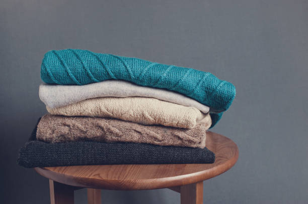 istock Stack of knitted clothes on the wooden table 1060126688