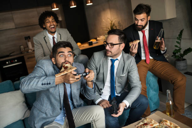 istock A group of young business man playing video games after work 1060127578
