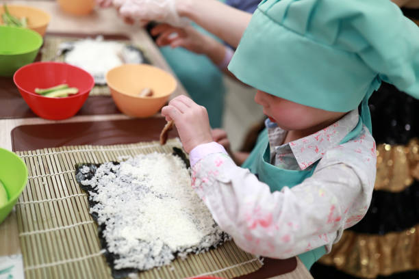 istock Boy putting sushi ingredients 1060129924