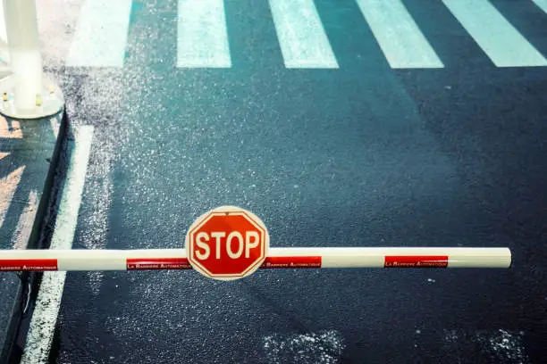 Photo of toll bar, stop sign, road, zebra crossing