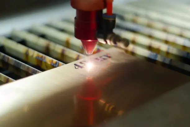 stage of manufacturing, laser engraving in automatic mode, close-up, blurred background