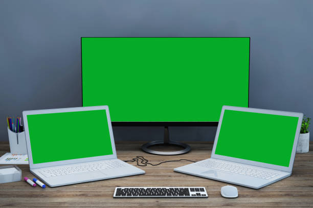 istock Office desk scenery with computer and laptop with blank screen mock-up 1060138072