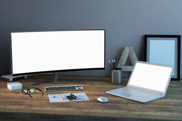 istock Office desk scenery with computer and laptop with blank screen mock-up 1060138568
