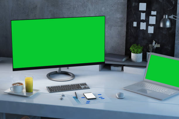 istock Office desk scenery with computer and laptop with blank screen mock-up 1060138584