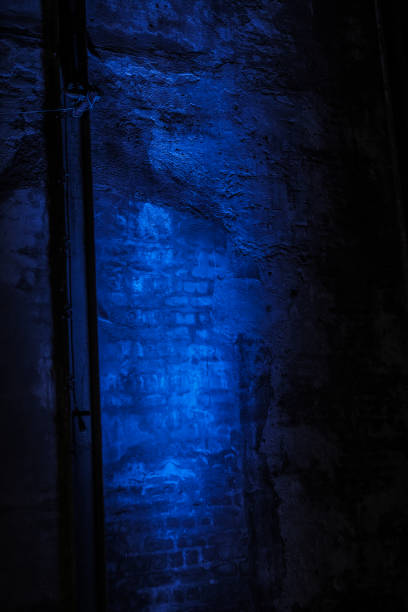 istock Blue light shining on and old industrial brick wall 1060140512