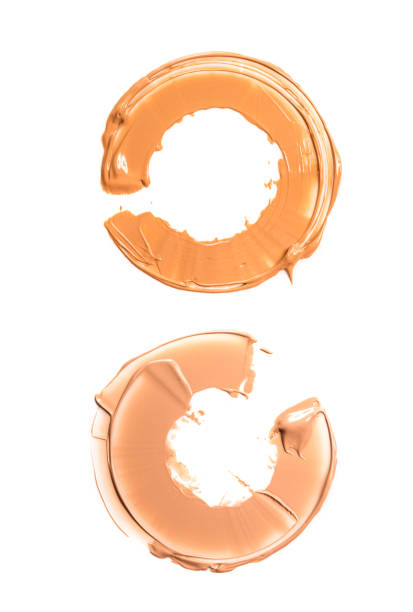 Two semicircles of foundation creams. The concept of persistence tonal base during the day. Two semicircles of foundation creams. The concept of persistence tonal base during the day. Isolated on white background liquid foundation face stock pictures, royalty-free photos & images