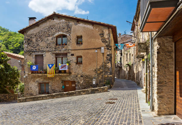 rue déserte avec vieux bâtiments dans un petit village de castellfollit de la roca, espagne - dormant volcano photos et images de collection