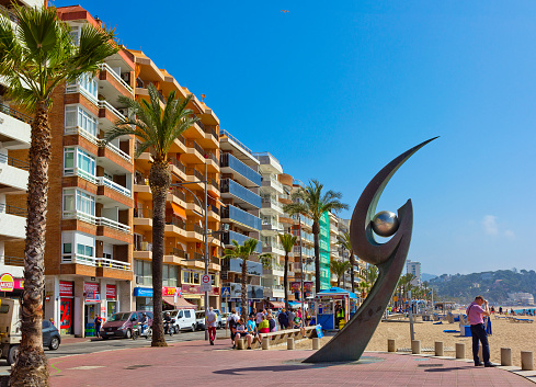 Lloret De Mar, Spain - April 27, 2018: Sea beach promenade Passeig d'Agustí Font with L'Esguard Monument. This sculpture was produced by Rosa Serra and was unveiled on 15th October 2000 to commemorate the International Meeting of Barcelona Supporters’ Clubs in Lloret de Mar