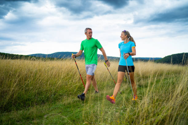 istock personal trainer explaining smiling woman correct nordic walking technique 1060153810