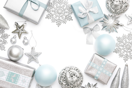 Silver and pastel blue christmas gifts, ornaments and decorations isolated on white background. Wrapped xmas boxes, christmas ornaments and baubles. Christmas border.
