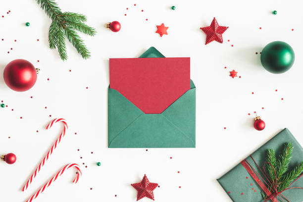 istock Christmas composition. Envelope, fir tree branches, red and green decorations on white background. Christmas, winter, new year concept. Flat lay, top view, copy space 1060167764