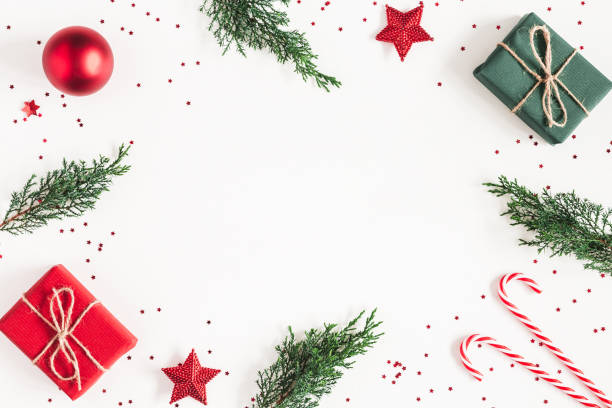 istock Christmas composition. Frame made of gifts, fir tree branches, red decorations on white background. Christmas, winter, new year concept. Flat lay, top view, copy space 1060169468