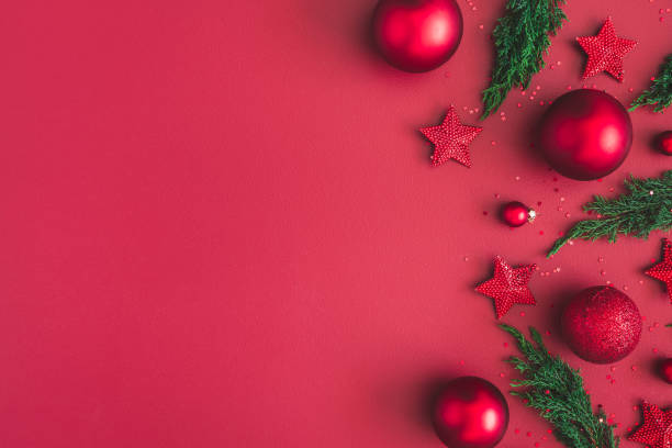 istock Christmas composition. Christmas red decorations, fir tree branches on red background. Flat lay, top view, copy space 1060170182
