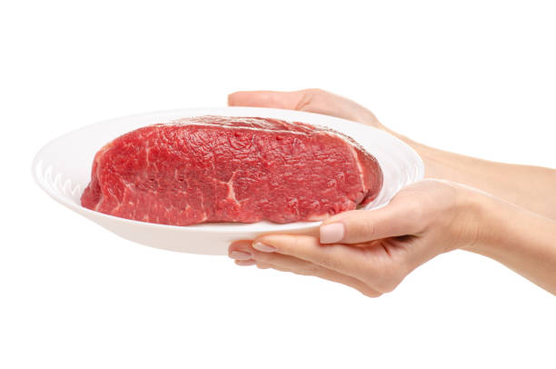 Beef meat on a plate in hand