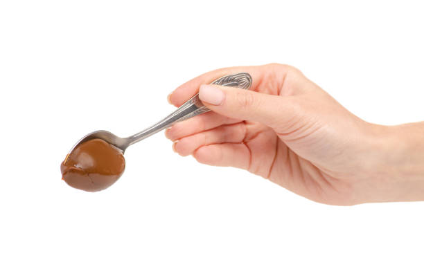 istock Boiled condensed milk in a spoon in hand 1060184802