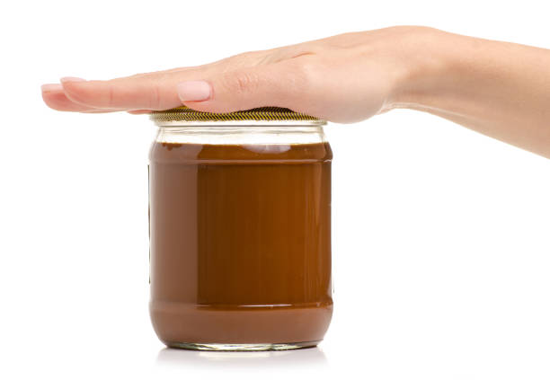 istock Jar boiled condensed milk in hand 1060184844