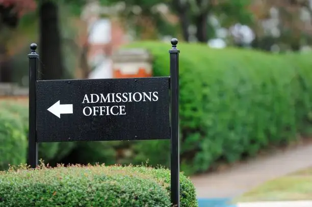 Close up of admissions office sign near public university campus