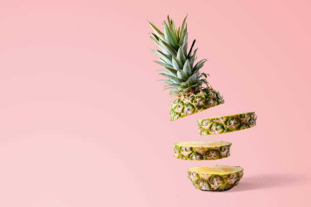 istock Sliced pineapple on pink bright background. Minimal fruit concep 1060193536