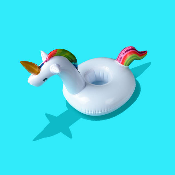 istock Inflatable unicorn pool toy on blue background. Minimal summer c 1060193664