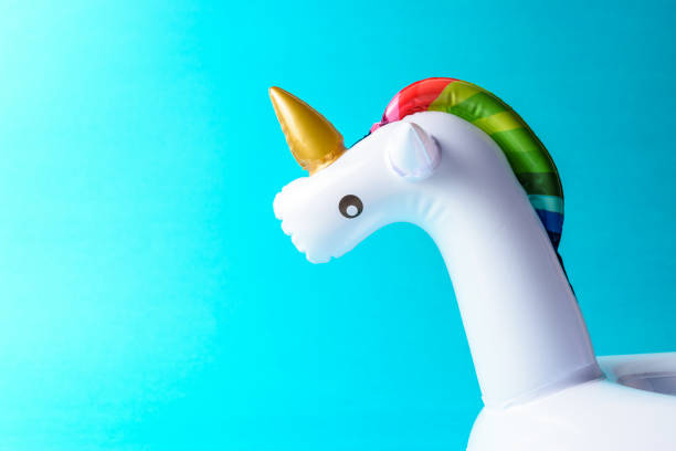 istock Inflatable unicorn pool toy on blue background. Minimal summer c 1060193698