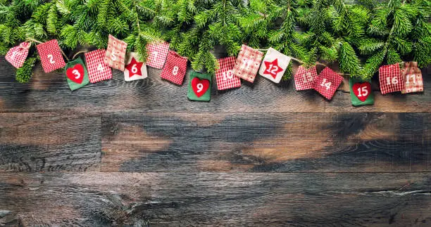 Christmas gifts Advent calendar on wooden background
