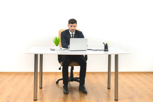 istock The businessman working at the desktop on the white wall background 1060200136