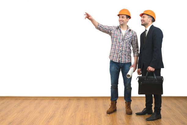 istock The two happy engineers gesture on the white wall background 1060201288