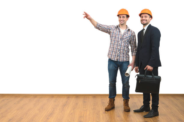 istock The two men in helmets gesture on the white wall background 1060201290