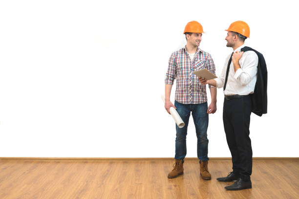 istock The engineer and a businessman stand with a tablet on the white wall background 1060201374