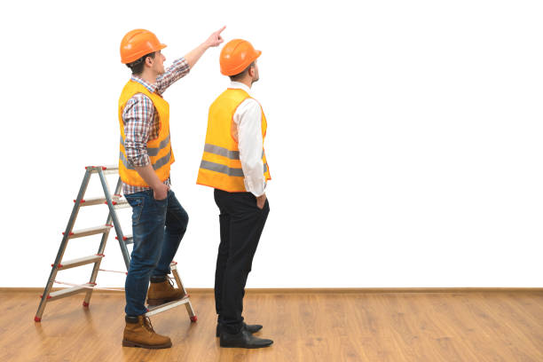 istock The two builders near ladder gesture on the white wall background 1060201384