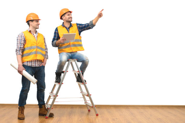 istock The two engineers near the ladder gesture on the white wall background 1060202578