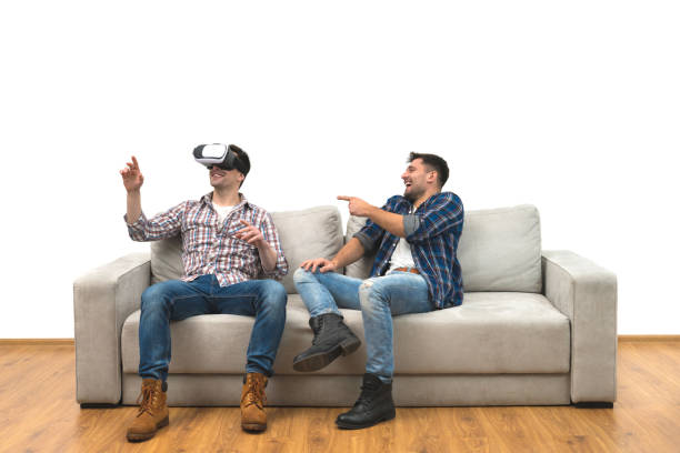 istock The two men with virtual glasses sitting on a sofa on the white wall background 1060203778