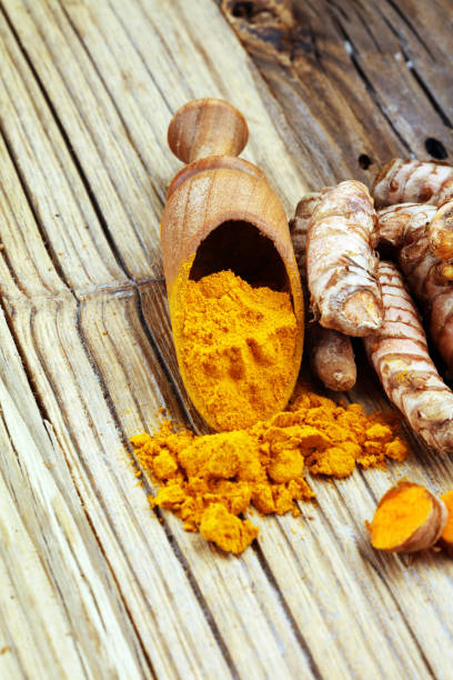 istock Turmeric powder and fresh turmeric on grey background 1060204074