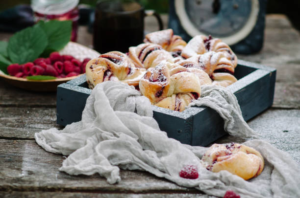 istock Buns with raspberries and powdered sugar in rustic style 1060204576