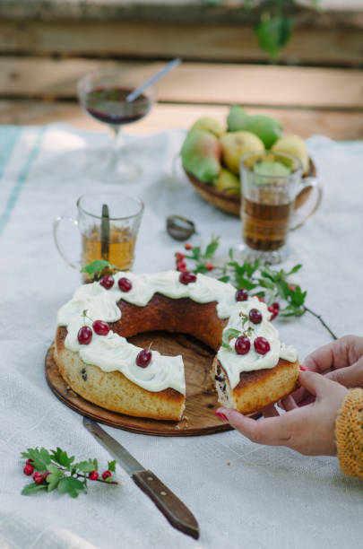 istock Bundt cake with cinnamon covered with white glaze on rustic background with autumn decorations 1060210620